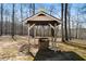 Rustic water well structure surrounded by trees, providing a natural water source at 680 Milligan Creek Rd, Roopville, GA 30170
