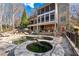 An outdoor living area boasts a multi-tiered patio, swimming pool and landscaped yard at 8069 Kenstone Ct, Sandy Springs, GA 30350
