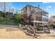 Backyard view with multiple levels, stone walkways, lush landscaping, and a glimpse of the pool at 8069 Kenstone Ct, Sandy Springs, GA 30350