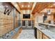 Full bar area with custom cabinetry, granite countertop, and sleek, modern design at 8069 Kenstone Ct, Sandy Springs, GA 30350