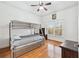 Bedroom with a bunk bed, window and ceiling fan at 8069 Kenstone Ct, Sandy Springs, GA 30350