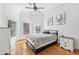 Bedroom featuring neutral decor, hardwood floors, and large windows providing natural light at 8069 Kenstone Ct, Sandy Springs, GA 30350