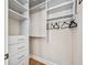 A walk-in closet featuring custom shelving and drawers at 8069 Kenstone Ct, Sandy Springs, GA 30350