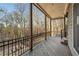 Lovely covered deck with stained wood flooring and wrought iron railings provides scenic outdoor living at 8069 Kenstone Ct, Sandy Springs, GA 30350