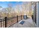 Outdoor deck with grill and railings offers wooded view at 8069 Kenstone Ct, Sandy Springs, GA 30350