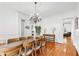 Dining room with hardwood floors, crown molding, and chandelier lighting at 8069 Kenstone Ct, Sandy Springs, GA 30350