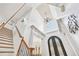 Bright, two-story foyer with high ceilings, elegant lighting, and staircase with metal railings at 8069 Kenstone Ct, Sandy Springs, GA 30350
