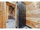 Hallway with a spiral staircase, wood paneled walls, storage cabinet, and tile floor at 8069 Kenstone Ct, Sandy Springs, GA 30350