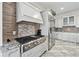 Modern kitchen with stainless steel appliances, granite countertops, and a stylish tile backsplash at 8069 Kenstone Ct, Sandy Springs, GA 30350