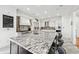 A gourmet kitchen with an oversized island, stainless steel appliances, and white cabinets at 8069 Kenstone Ct, Sandy Springs, GA 30350