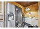 Gourmet kitchen featuring stainless steel refrigerator, custom cabinets, and a separate beverage cooler at 8069 Kenstone Ct, Sandy Springs, GA 30350