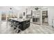 A chef's kitchen with expansive island, stainless steel appliances, and light tile flooring at 8069 Kenstone Ct, Sandy Springs, GA 30350