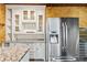 Modern kitchen featuring stainless steel appliances, custom cabinets, and granite countertops at 8069 Kenstone Ct, Sandy Springs, GA 30350