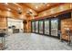 Large entertainment space boasting floor-to-ceiling glass doors that connect to an outdoor living area at 8069 Kenstone Ct, Sandy Springs, GA 30350