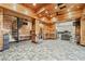 Expansive living area featuring wood-paneled walls and ceilings, with a kitchenette and a spiral staircase at 8069 Kenstone Ct, Sandy Springs, GA 30350