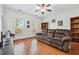 Cozy living room with hardwood floors, a plush sofa, and ample natural light creates a comfortable space at 8069 Kenstone Ct, Sandy Springs, GA 30350