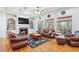 Cozy living room with a fireplace, hardwood floors, built-in shelving, and lots of seating at 8069 Kenstone Ct, Sandy Springs, GA 30350