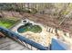 Aerial view of a private swimming pool and deck surrounded by trees at 8069 Kenstone Ct, Sandy Springs, GA 30350
