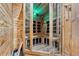 Inviting wooden sauna featuring glass door, wood benches, and integrated lighting at 8069 Kenstone Ct, Sandy Springs, GA 30350