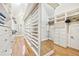 Custom walk-in closet with built-in shelving and drawers, offering ample storage space and organization at 8069 Kenstone Ct, Sandy Springs, GA 30350
