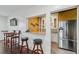 Elegant wet bar featuring granite countertops, custom cabinetry, and stainless steel appliances at 8069 Kenstone Ct, Sandy Springs, GA 30350