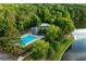 Aerial view of community pool, tennis court, clubhouse, and lakeside setting at 210 Trailmore Ct, Roswell, GA 30076