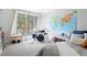 Bright bedroom featuring a large window, world map, and unique decor at 210 Trailmore Ct, Roswell, GA 30076