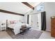 Bright bedroom with vaulted ceiling, exposed beam, large windows, and cozy bedding at 210 Trailmore Ct, Roswell, GA 30076