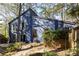 Blue home exterior with mature trees and a spacious backyard at 210 Trailmore Ct, Roswell, GA 30076