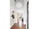 Bright foyer with hardwood floors, modern lighting, and a view into other living spaces at 210 Trailmore Ct, Roswell, GA 30076