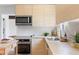 Well-lit kitchen features bright counter tops, stainless steel appliances, and modern finishes at 210 Trailmore Ct, Roswell, GA 30076