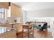 Bright kitchen boasts wood cabinetry, stainless appliances, and an adjacent living area at 210 Trailmore Ct, Roswell, GA 30076