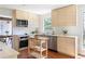 Modern kitchen features custom wood cabinets, stainless steel appliances, and center island at 210 Trailmore Ct, Roswell, GA 30076