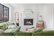Living room features a cozy fireplace, stone hearth, and views of the outside at 210 Trailmore Ct, Roswell, GA 30076