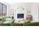 Relaxing living area featuring a stone fireplace, large windows, and comfortable seating at 210 Trailmore Ct, Roswell, GA 30076