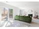 Bright living room featuring a green velvet sofa, fireplace, and sliding glass doors to the backyard at 210 Trailmore Ct, Roswell, GA 30076