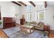 Bright living room with large windows, hardwood floors, and comfortable seating at 210 Trailmore Ct, Roswell, GA 30076