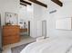 Spacious bedroom featuring exposed beams, modern decor, and access to a private ensuite bathroom at 210 Trailmore Ct, Roswell, GA 30076