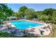 Community pool featuring a diving board, lounge chairs, and manicured landscaping at 210 Trailmore Ct, Roswell, GA 30076