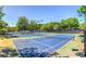 Aerial view of pristine tennis courts, providing ample recreational space near a lake at 210 Trailmore Ct, Roswell, GA 30076