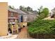Manicured backyard features a wooden deck with gazebo and other homes in the community at 5877 Stow Dr, Tucker, GA 30084