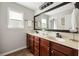 A well-lit bathroom features double sinks, a large mirror, and neutral tones for a clean and modern look at 5877 Stow Dr, Tucker, GA 30084