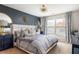A stylish primary bedroom features modern decor, a large window, and comfortable bedding at 5877 Stow Dr, Tucker, GA 30084
