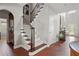 Inviting entryway with hardwood floors, staircase, and access to a butler's pantry and features high ceilings at 5877 Stow Dr, Tucker, GA 30084