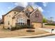 Side view of a two-story home featuring mixed siding, manicured landscaping, and an attached garage at 5877 Stow Dr, Tucker, GA 30084