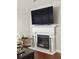 Fireplace with a white mantel and a large television mounted above the fireplace at 5877 Stow Dr, Tucker, GA 30084