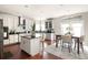 Well-lit kitchen featuring an island, stainless appliances, and dining area at 5877 Stow Dr, Tucker, GA 30084