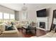Spacious living room features a fireplace, hardwood floors, a white sectional couch, and large windows at 5877 Stow Dr, Tucker, GA 30084