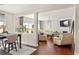 Open concept living room and dining area featuring hardwood floors and lots of natural light at 5877 Stow Dr, Tucker, GA 30084