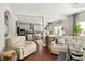 Open concept living room and kitchen with hardwood floors, lots of seating, and lots of natural light at 5877 Stow Dr, Tucker, GA 30084